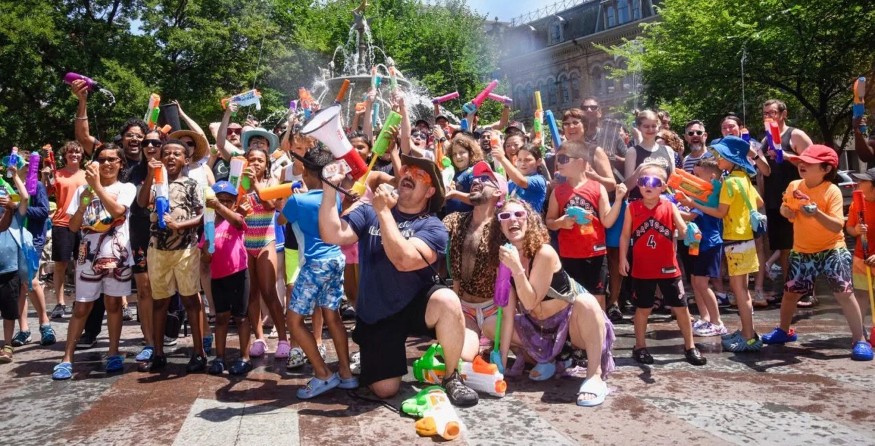 Adults gather at Berczy Park for free giant water gun fight Saturday